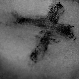 Ash Wednesday Cross in ashes on human skin