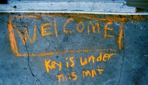 Chalked Message: Welcome: Key is under mat