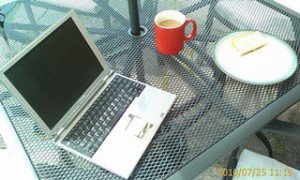 Laptop and working lunch. An outside table with a silver laptop, coffee and a sandwich on it. © rcp:051010:a0021 This image is released under a Creative Commons Attribution only (free) license.